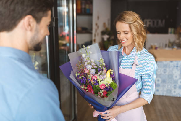 istock florist and buyer with bouquet 844126426