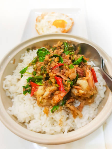 istock Spicy fried shrimp with basil leaves on cooked rice 844129098