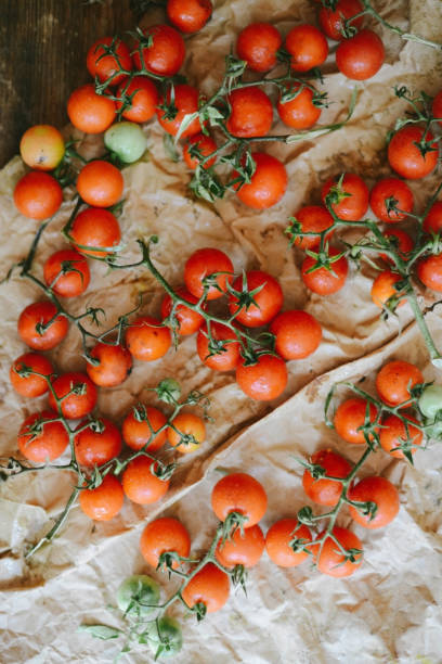 istock Fresh cherry tomatoes on rustic wooden table, Top view with copy space. 844129286