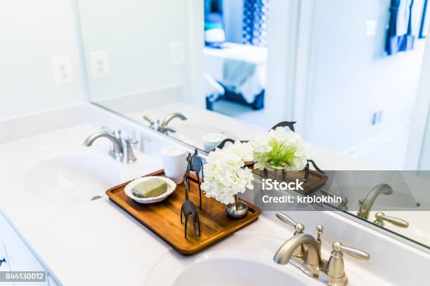 Closeup Of Modern Bathroom His And Her Sinks With White Countertop And Mirror In Staging Model Home House Or Apartment Stock Photo - Download Image Now