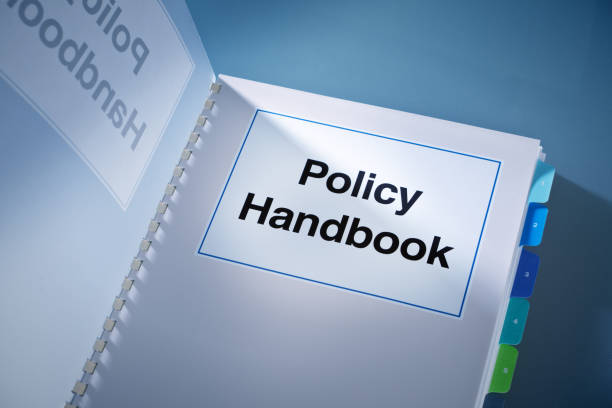 A Corporate Policy Plan Document Manual Book Still Life A still life of a working Corporate Policy book. A fundamental document that guide a business venture, its organizational rules, its internal and external conducts and established policy for various conditions and situations. handbook stock pictures, royalty-free photos & images