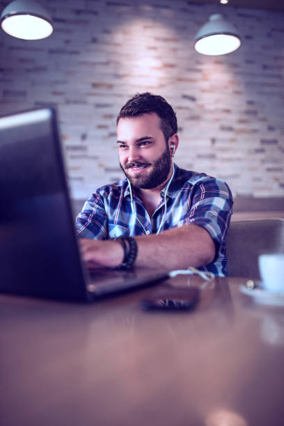 istock Young Freelancer Working on his Laptop in a Cafe 844132548