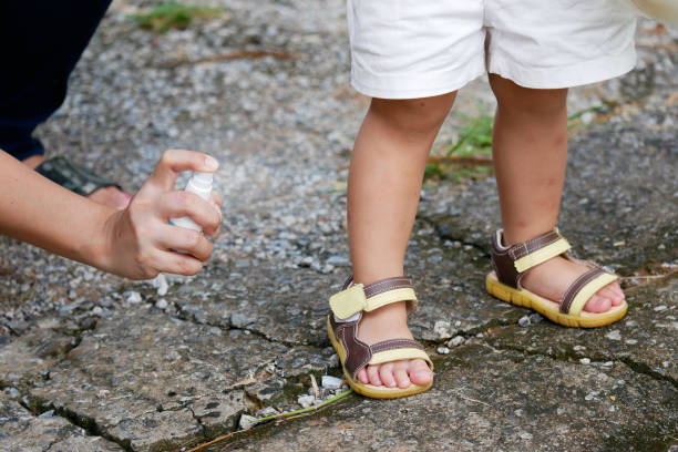 mother spraying insect or mosquito repellents on skin girl, mosquito repellent for babies, toddlers that will protect your children from mosquitoes and other insects - insect repellant imagens e fotografias de stock