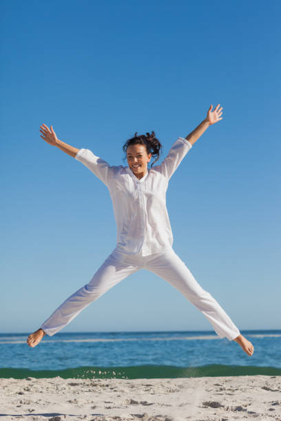 istock Smiling woman jumping up 844138764