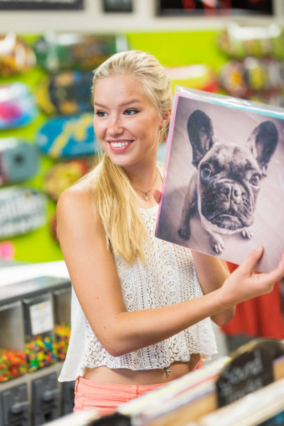 mujer joven en la tienda de discos - fan deck fotografías e imágenes de stock