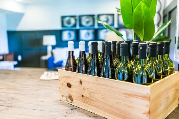 Closeup of wooden crate of wine bottles on table in room in home, house or apartment