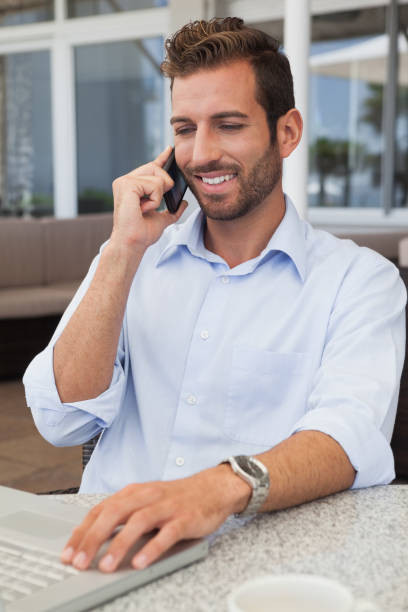istock Happy businessman talking on phone using his laptop 844148006
