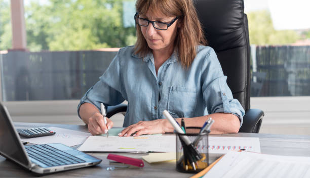istock Mature businesswoman working on documents 844148688