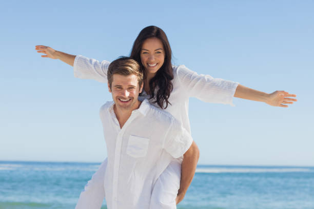 istock Woman sitting on mans back smiling at camera 844167100
