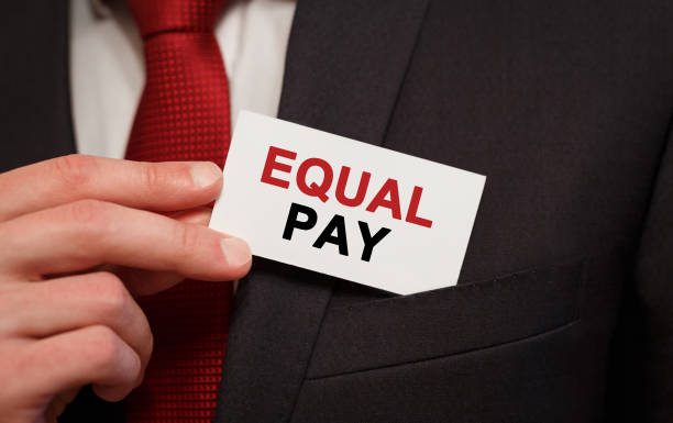 istock Businessman putting a card with text Equal Pay in the pocket 844167382