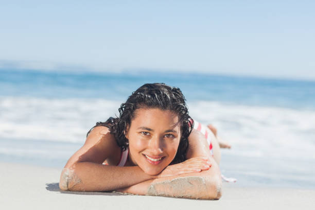 istock Beautiful woman lying down on the beach 844168462