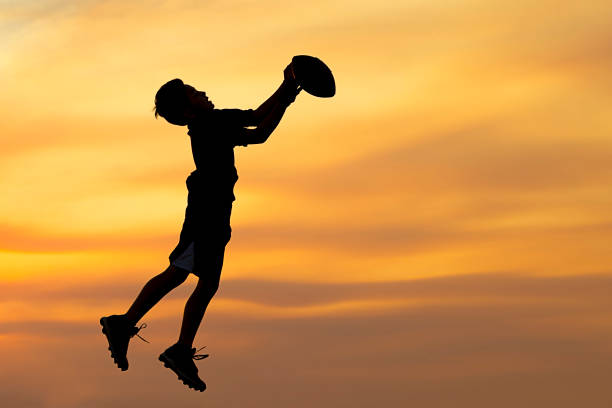 istock Silhouette of boy playing ball. 844174164