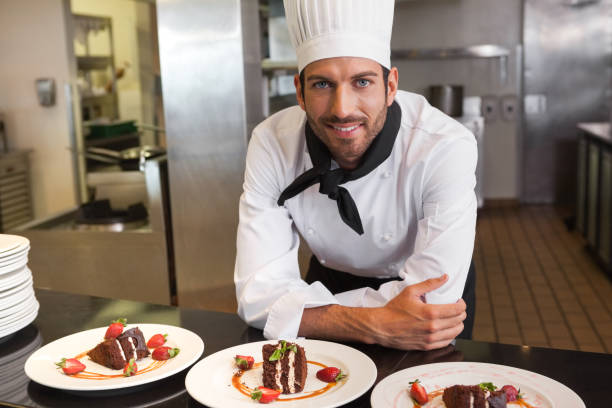 istock Happy chef looking at camera behind counter of desserts 844174532