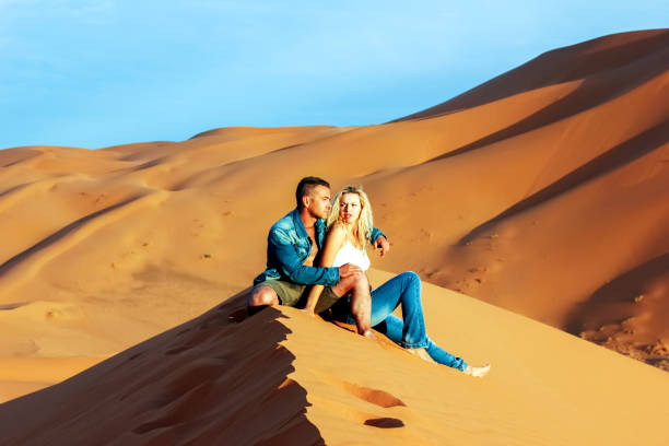 istock Guy and girl on the sand dunes in the Sahara Desert. 844175708