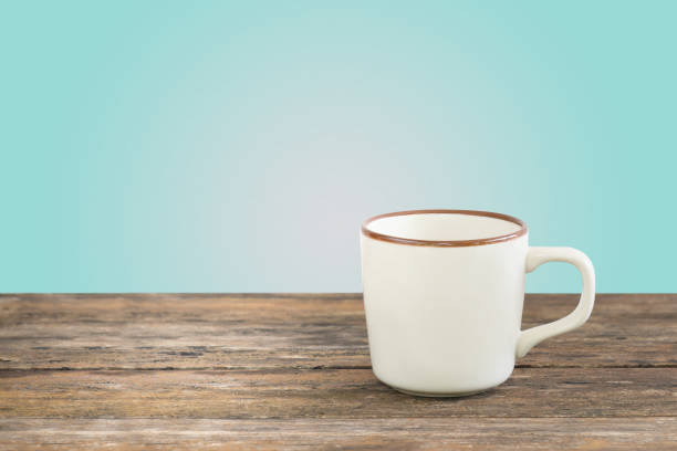 istock A coffee mug on wooden plank,green background with copy space. 844175920