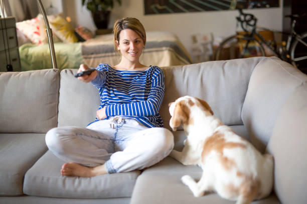 istock woman sitting on the couch take some good time with his dog 844176596