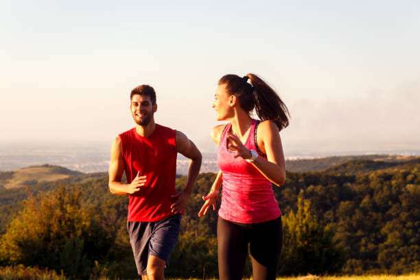 istock Young couple running in nature on sunset and having fun. 844179554