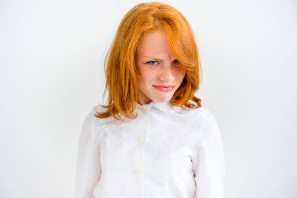 Portrait close up of happy beautiful young woman thinking looking away, up isolated grey wall background with copy space. Human face expressions, emotions feelings, body language, attitude perception