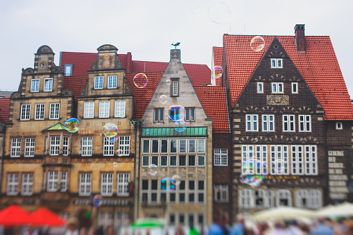 View of Bremen market square with Town Hall, Roland statue and crowd of people, historical center, Germany