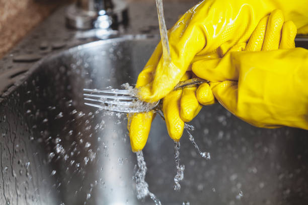 istock Hands in yellow rubber gloves wash  plug in sink 844180160