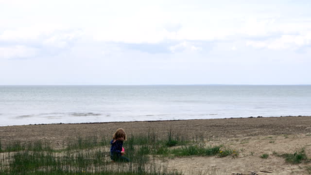 Little Girl Playing in the Sand of Lake Ontario Runs Towards the Camera