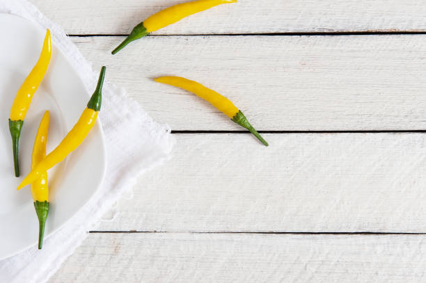 yellow hot peppers on a white background