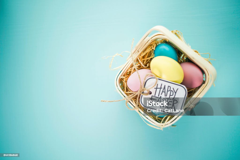 Easter background with pastel colored eggs Easter Basket Stock Photo