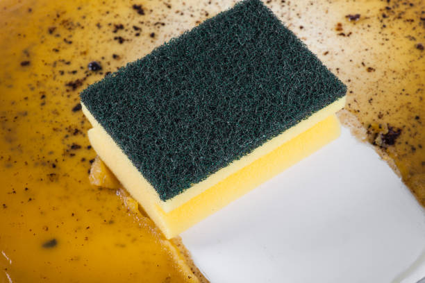 Sponge in clean a frying pan stock photo
