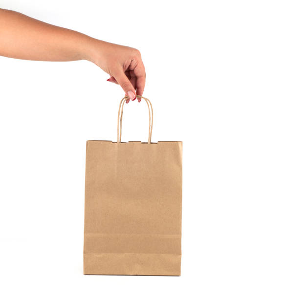 istock A female hand holds a paper bag 844190206