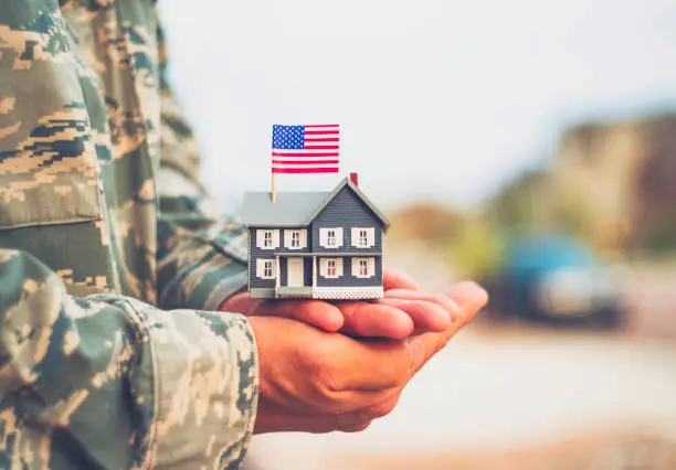 American military soldier with house. Relocation theme