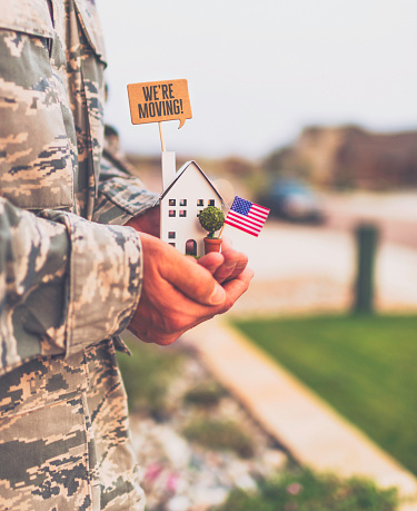 American military soldier with house and sign. Relocation theme