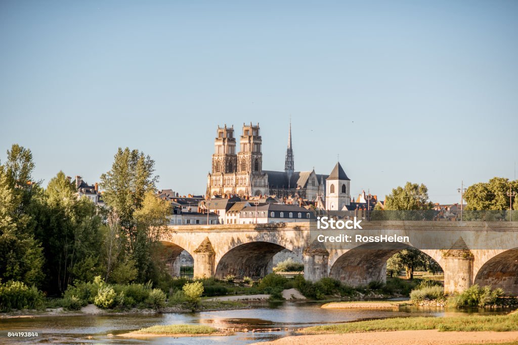 Orleans city in France Landscape view on the river and old arch bridge in Orleans city during the sunset in France Orleans - France Stock Photo