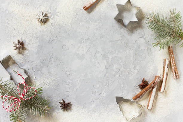 istock Ingredients for Christmas baking - spices, powdered sugar and cookie shapes on a stone background. Seasonal, food background. 844194852
