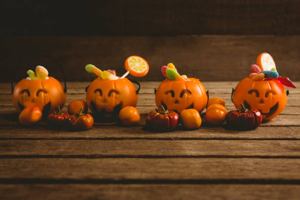 istock Jack o lantern containers with food arranged on table 844198442