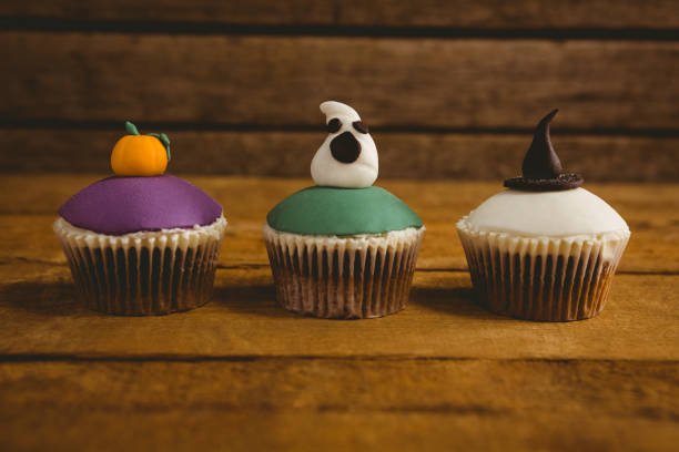 istock Close up of Halloween cup cakes arranged on table 844198978