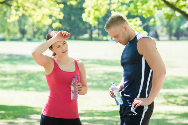 istock Tired Couple Holding Bottles In Park 844199064