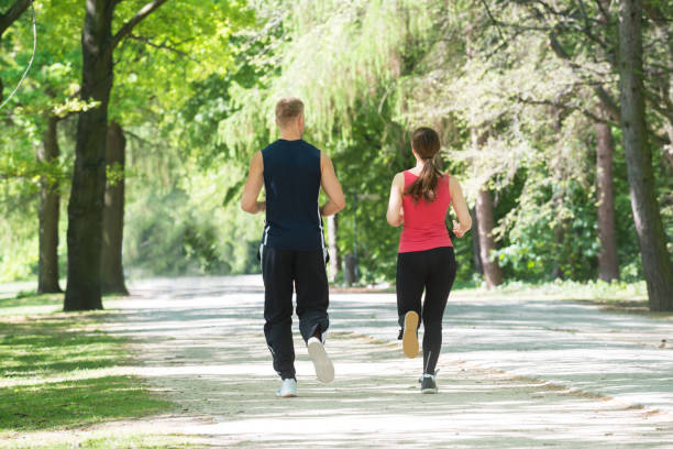 istock Young Couple Jogging In Park 844199310