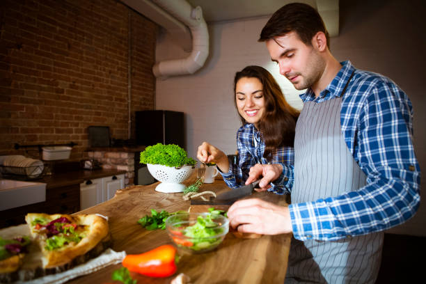 istock Young man and woman cooking together at kitchen 844199544