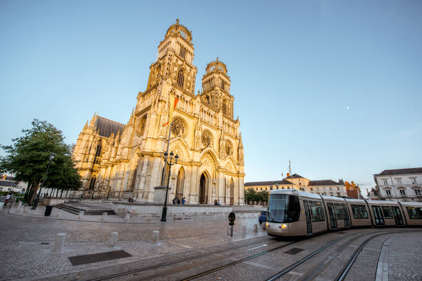 Orleans city in France Street view on the saint Croix cathedral with tram in Orleans city during the sunset in central France orleans france photos stock pictures, royalty-free photos & images