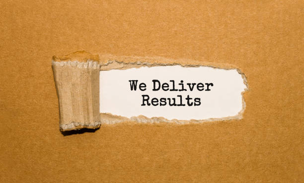 istock The text We Deliver Results appearing behind torn brown paper 844206464