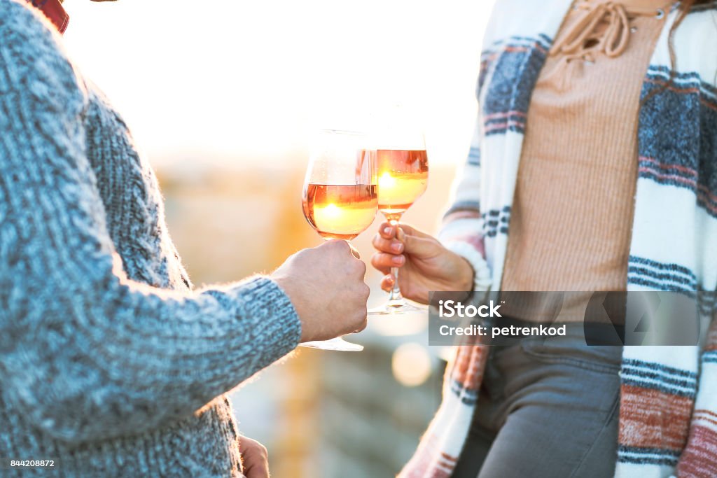 Man and woman with wineglasses outdoors Man and woman with glass of rose wine on summer beach picnic Autumn Stock Photo