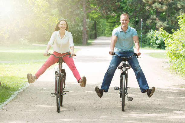 istock Happy Couple Riding Bicycle In Park 844212652