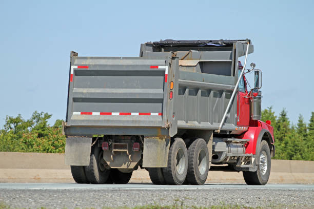 Boom truck being driven on a highway.