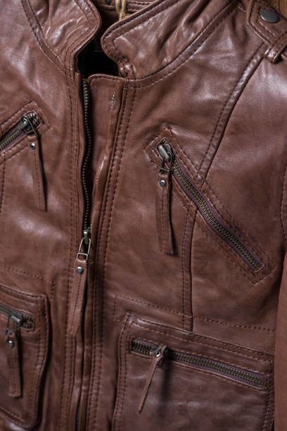istock Brown textured leather jacket. Leather jacket macro details. Jacket zippers and pockets 844216580