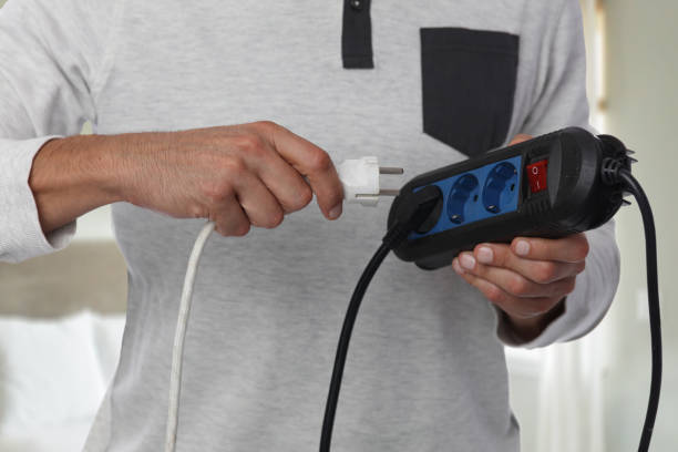 istock Energy saving concept. Man holding electric power extension cord. 844219834