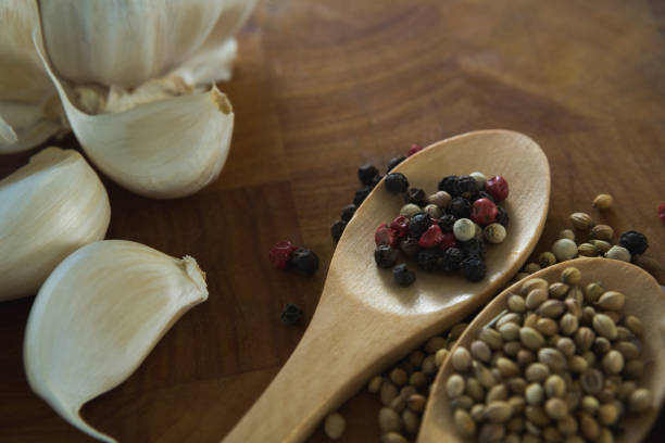 istock Garlic bulbs and spices on wooden board 844222940