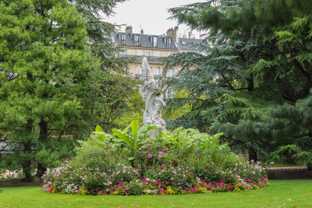 Paris, the Luxembourg garden, angel statue and a luxury building in background