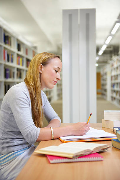 Young woman working in library Falmouth, England falmouth harbor stock pictures, royalty-free photos & images