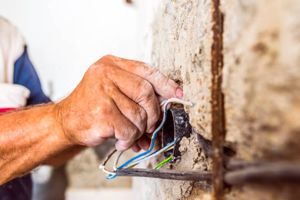 istock Hands of electrician with pliers during working on  wires 844232680