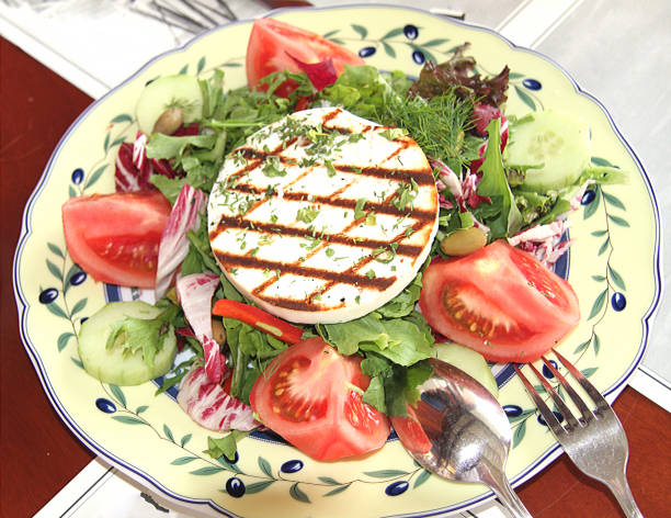 Salad of tomato, arugula, olives, cucumbers, pepper and toasted cheese